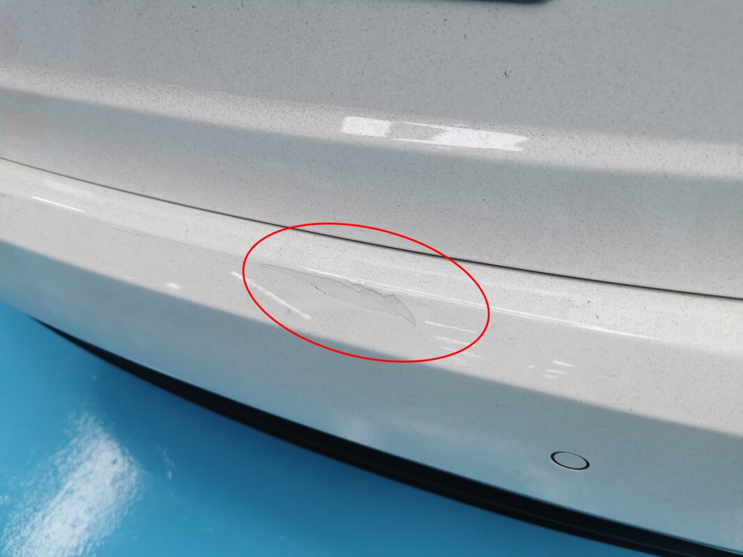 Close-up of paint damage on the Maserati Ghibli before work begins.