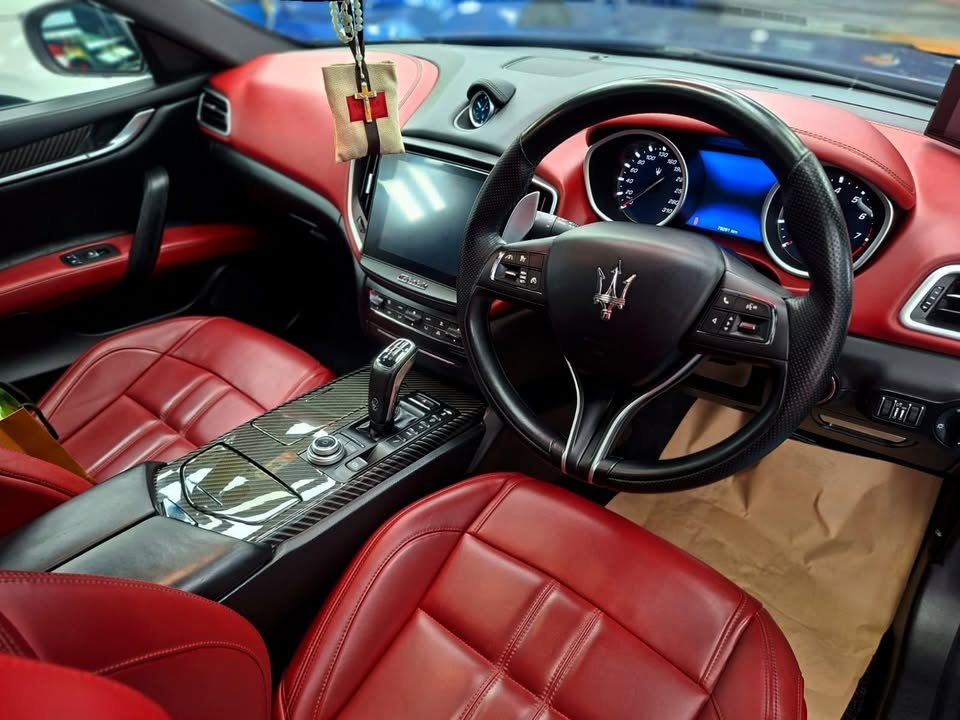 Ghibli interior with red leather seats and black dashboard.