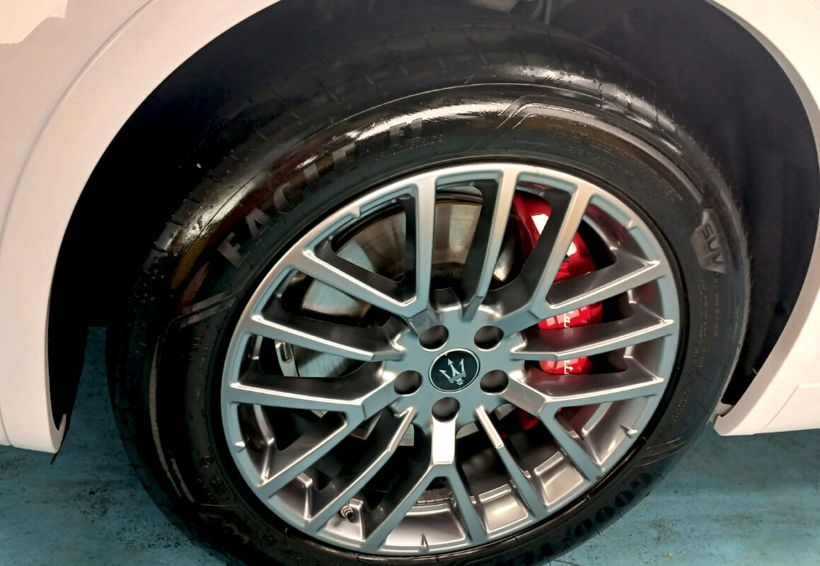 The coated bonnet of the Maserati Grecale under workshop lighting.