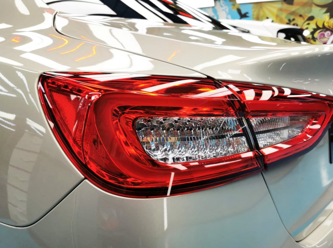 The coated bonnet of the Maserati Quattroporte GranLusso under workshop lighting.