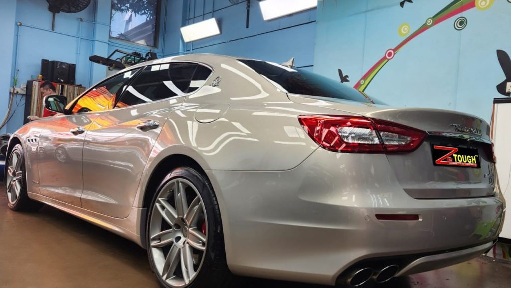 Rear quarter of the Maserati Quattroporte, glossy and protected.
