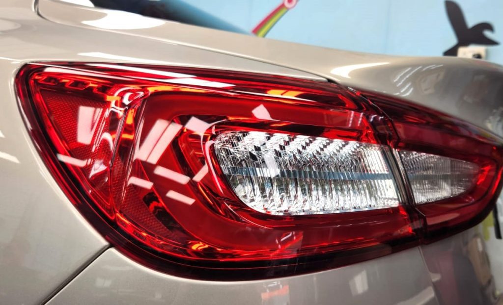 The coated bonnet of the Maserati Quattroporte under workshop lighting.