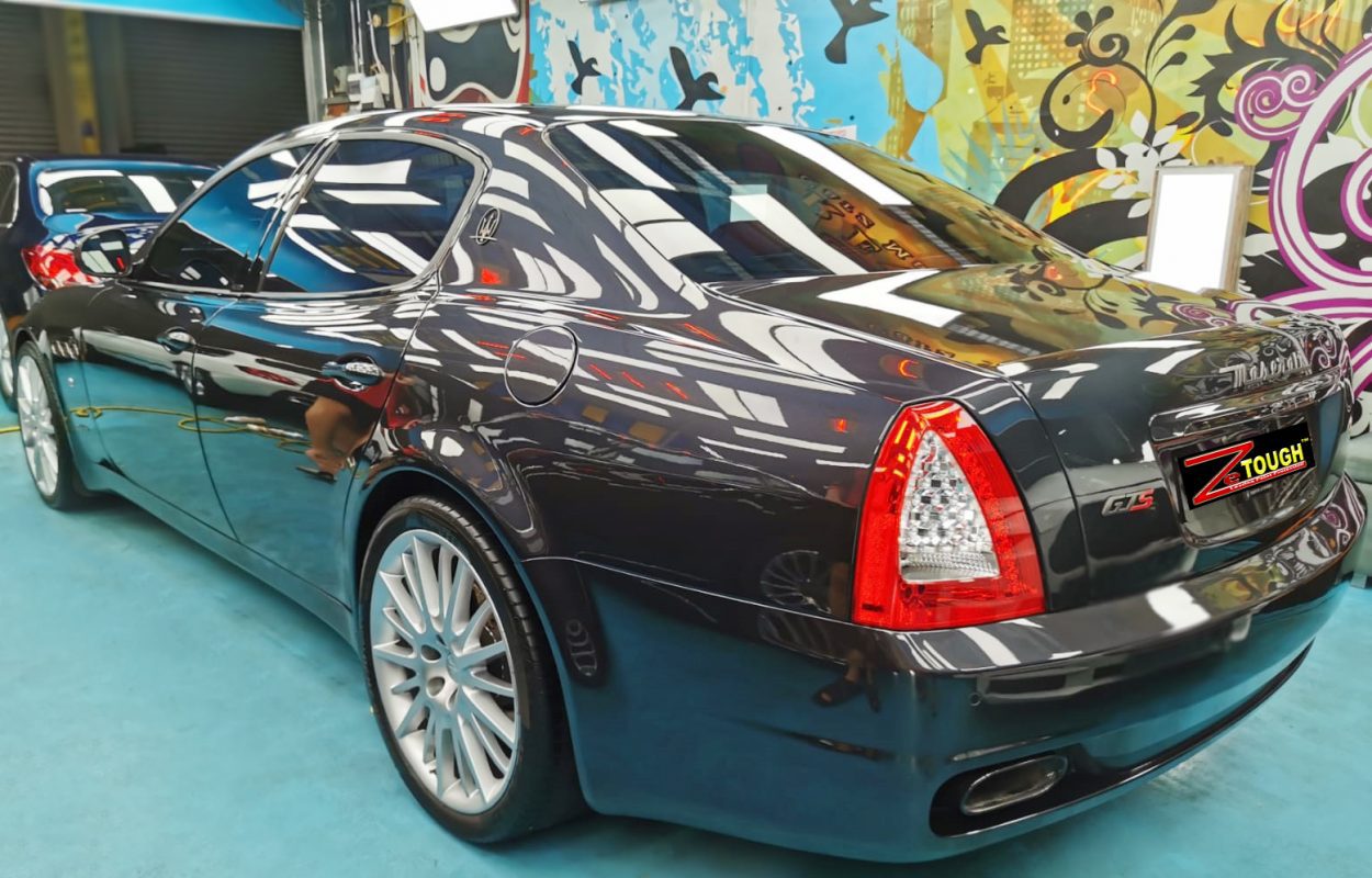 Rear quarter of the Maserati Quattroporte, glossy and protected.