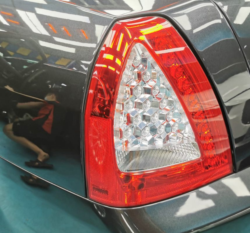 The coated bonnet of the Maserati Quattroporte under workshop lighting.