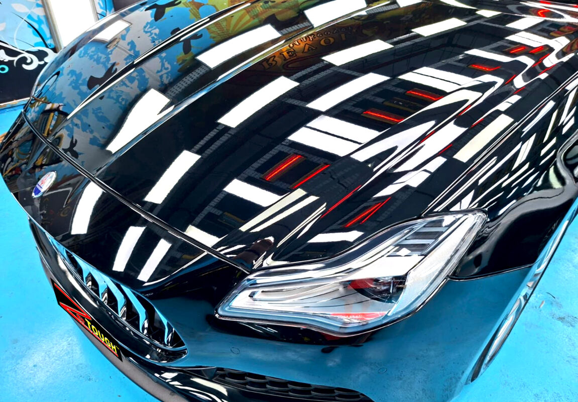 The Maserati Quattroporte's coated paintwork under workshop lighting.