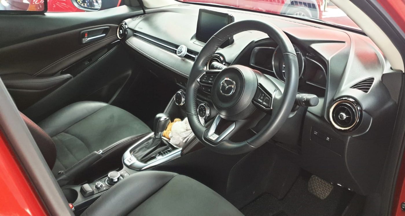 The Mazda 2 parked in the workshop, freshly coated.