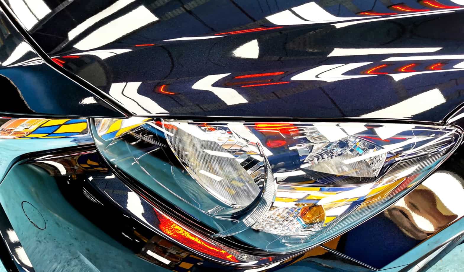The Mazda 2's coated paintwork showing clean reflections.
