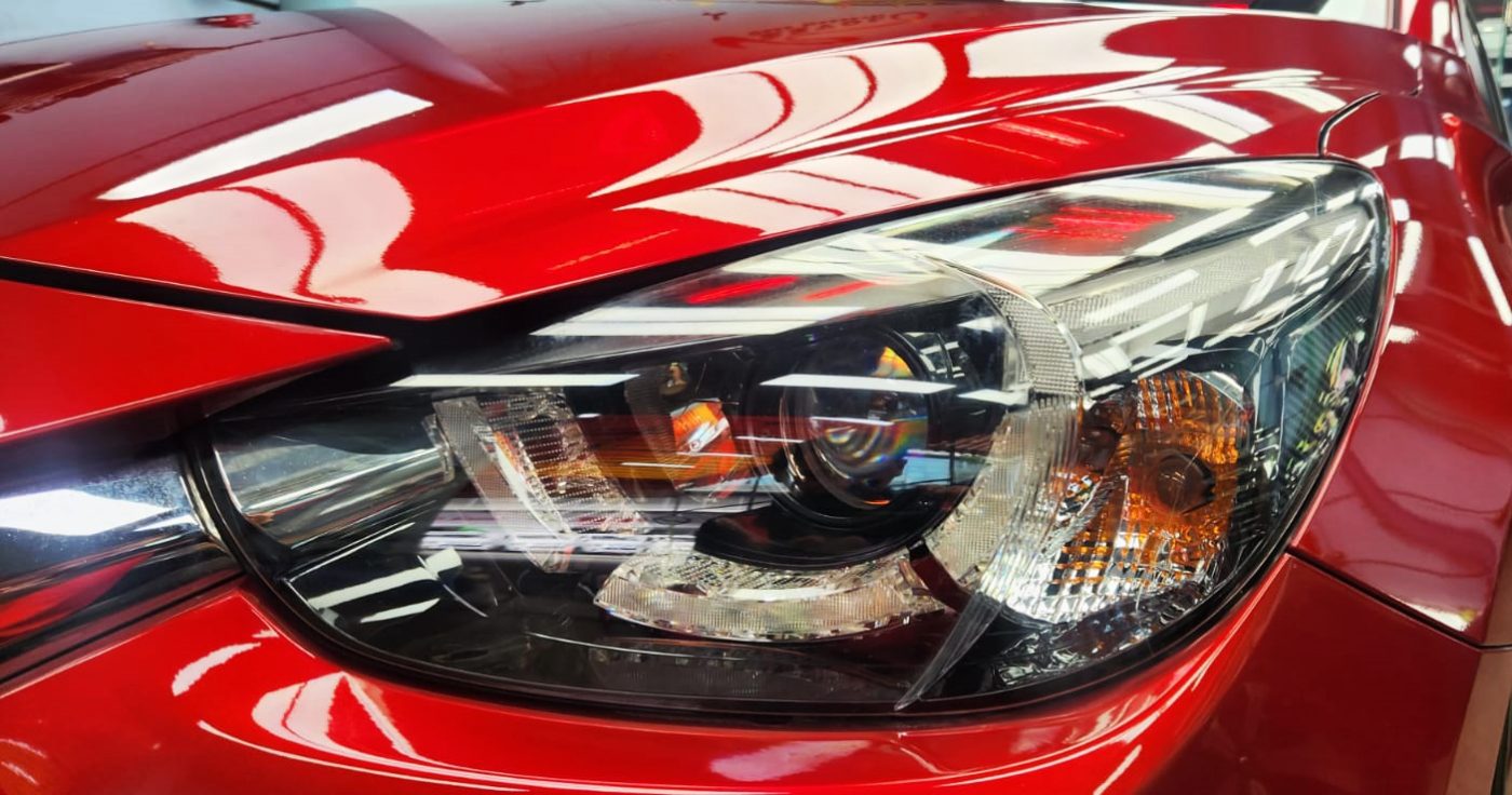 The Mazda 2's coated paintwork showing clean reflections.