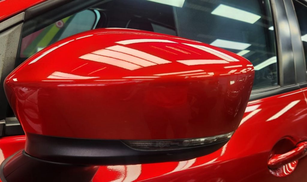 The Mazda 2 parked in the workshop, freshly coated.