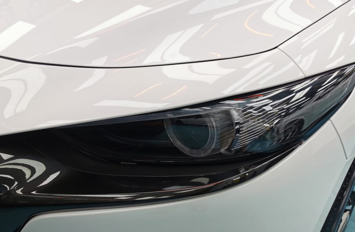 The Mazda 3's coated paintwork showing clean reflections.