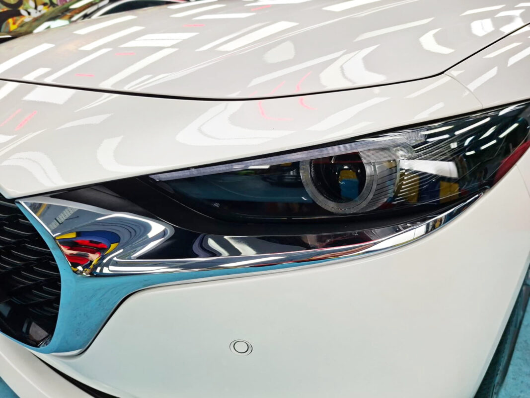 The Mazda 3's coated paintwork showing clean reflections.