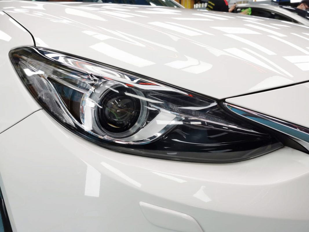 The Mazda 3's coated paintwork showing clean reflections.