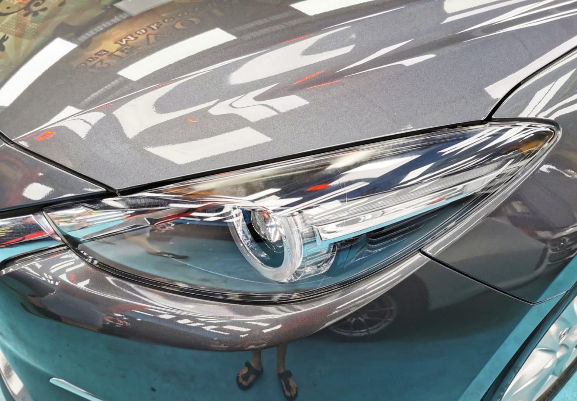 The Mazda 3's coated paintwork showing clean reflections.