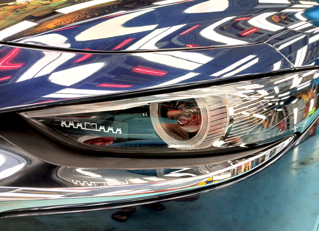 The Mazda 3's coated paintwork showing clean reflections.