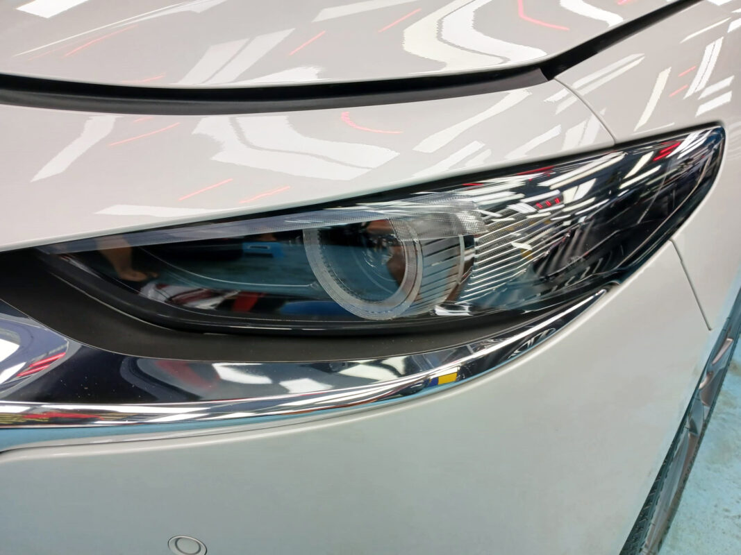 The Mazda 3's coated paintwork showing clean reflections.