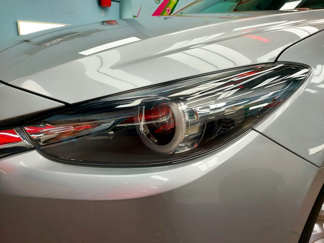 The Mazda 3's coated paintwork showing clean reflections.
