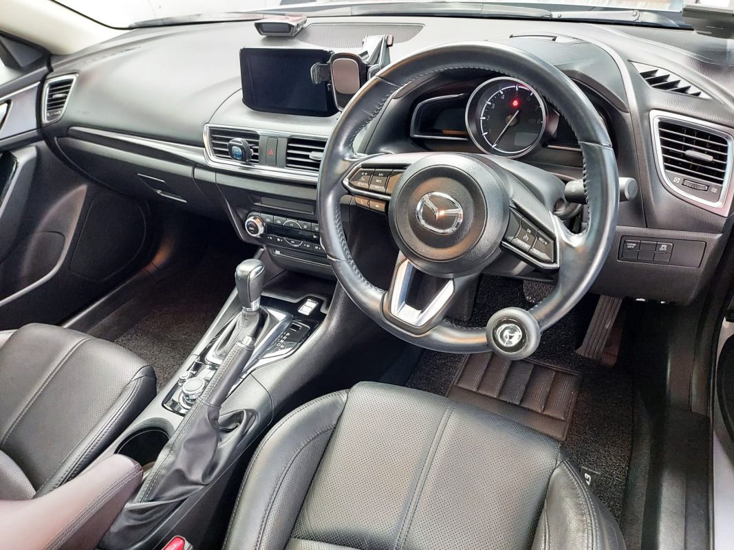 The Mazda 3 parked in the workshop, freshly coated.