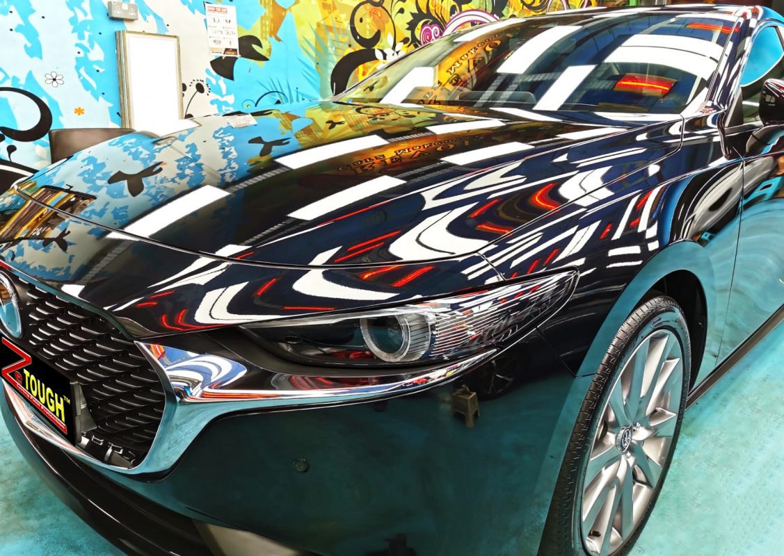 The Mazda 3 from a side angle after the ceramic coating.