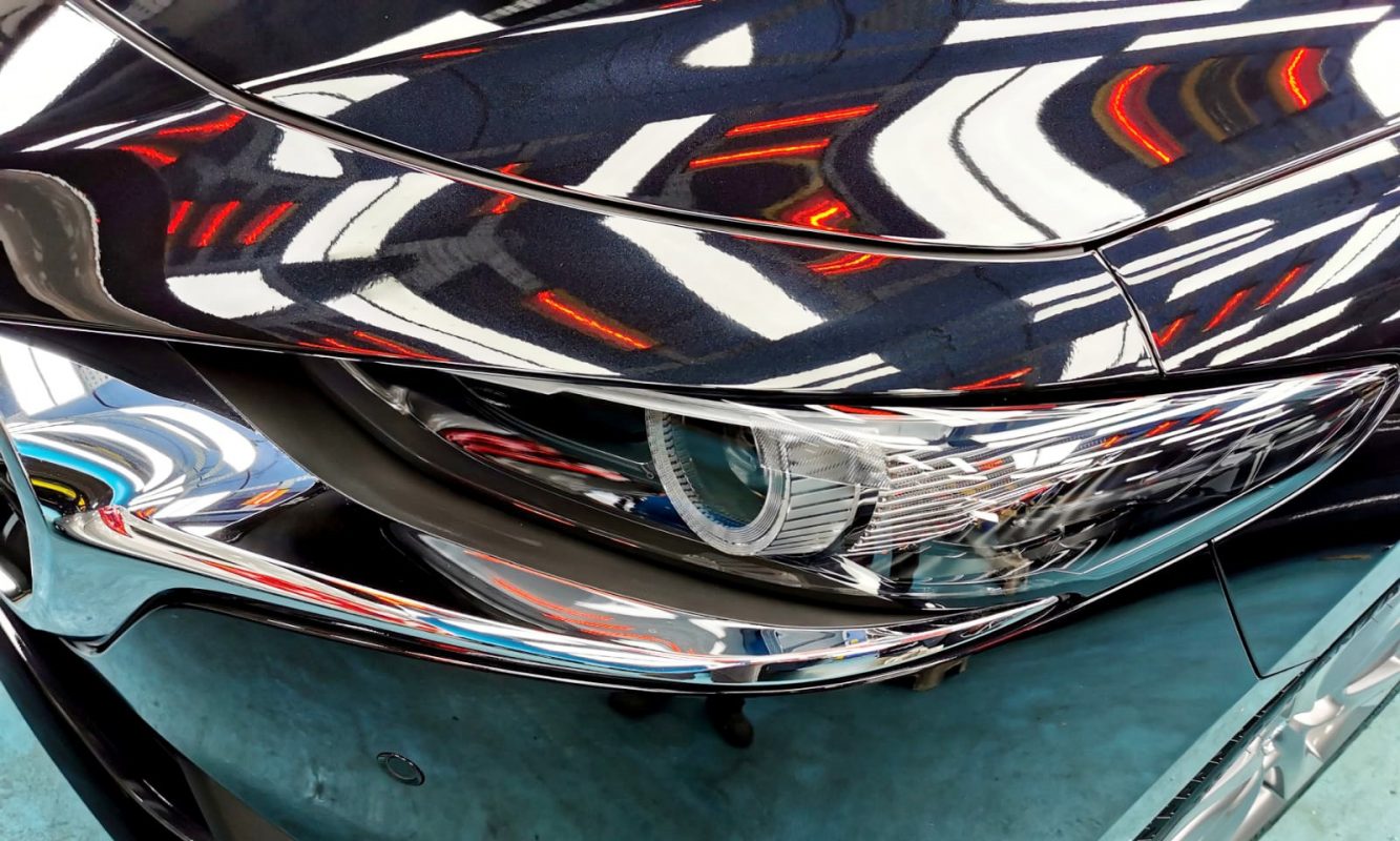 The Mazda 3's coated paintwork showing clean reflections.