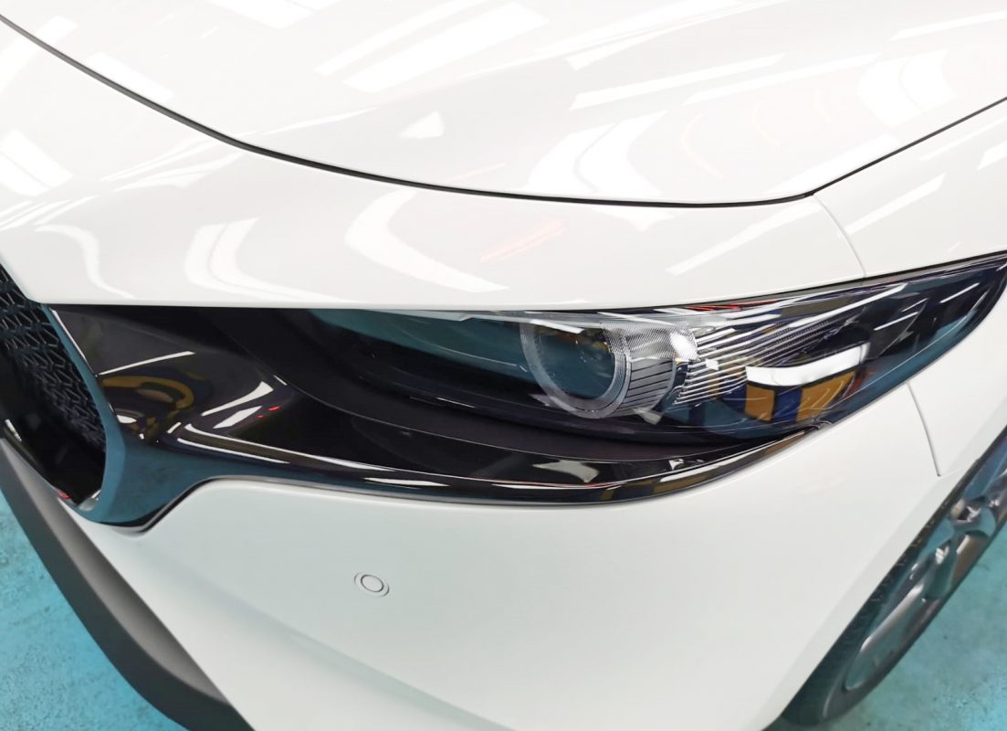 The Mazda 3's coated paintwork showing clean reflections.