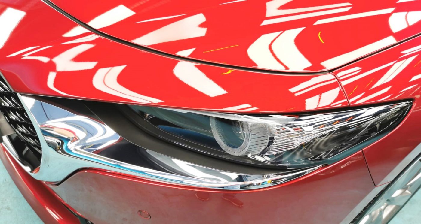 The Mazda 3's coated paintwork showing clean reflections.