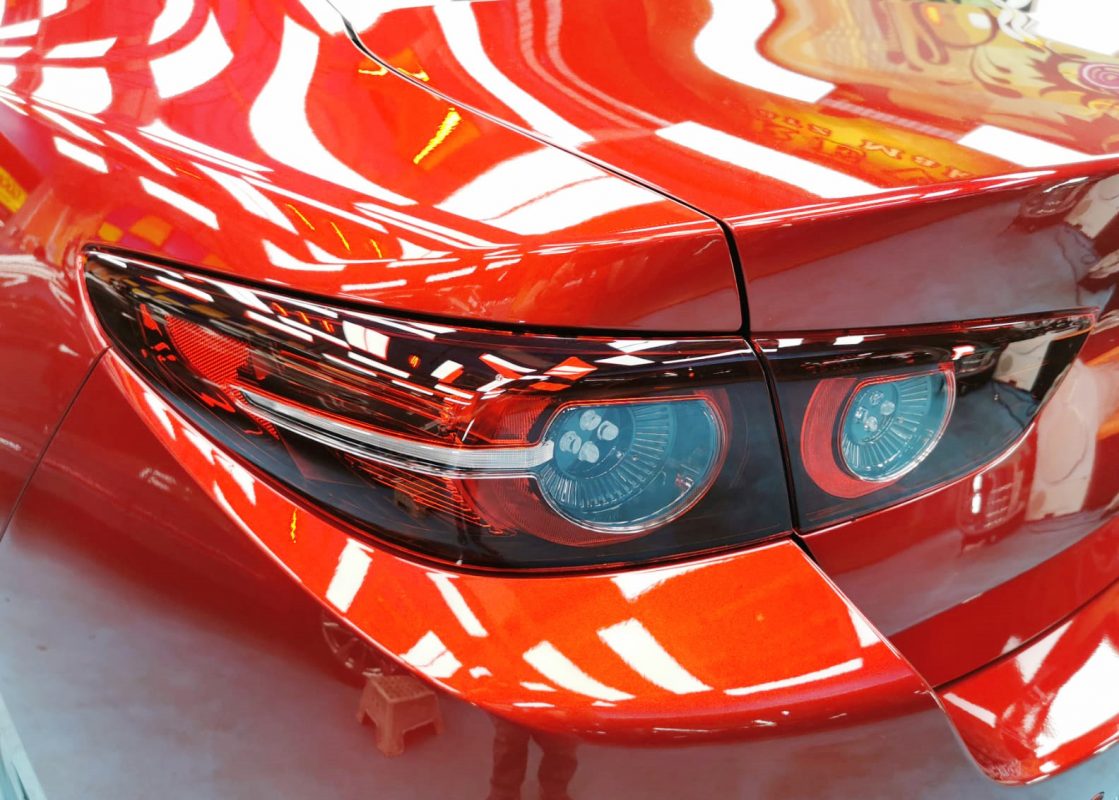 The coated bonnet of the Mazda 3 under workshop lighting.