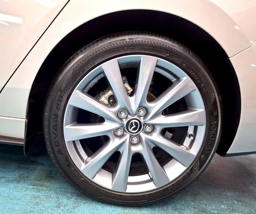 Close-up of the silver multi-spoke Mazda alloy wheel.