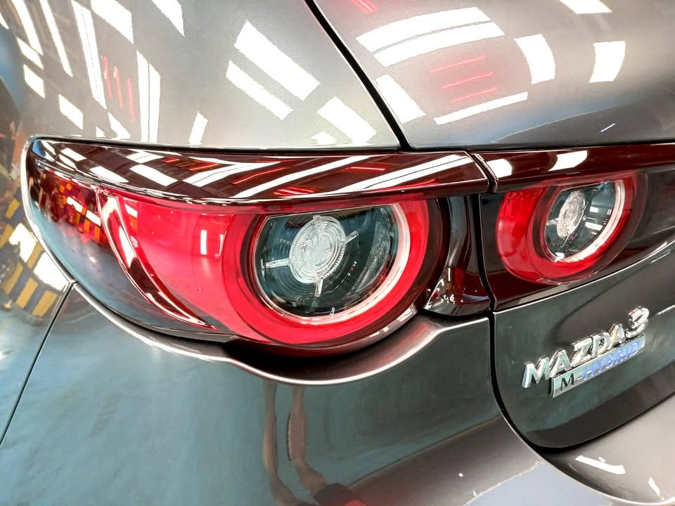 Close-up of the round tail lights and Mazda 3 badge on the tailgate.