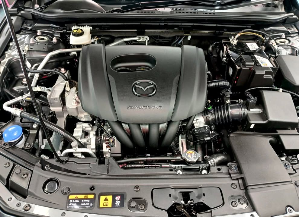 Engine bay with the Mazda engine cover.