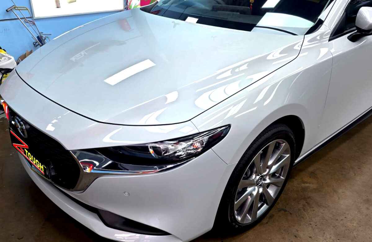 The Mazda 3's coated paintwork under workshop lighting.