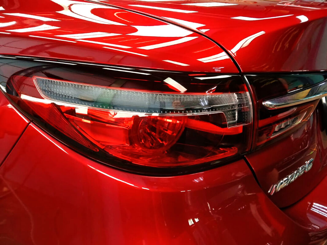 The coated bonnet of the Mazda 6 under workshop lighting.