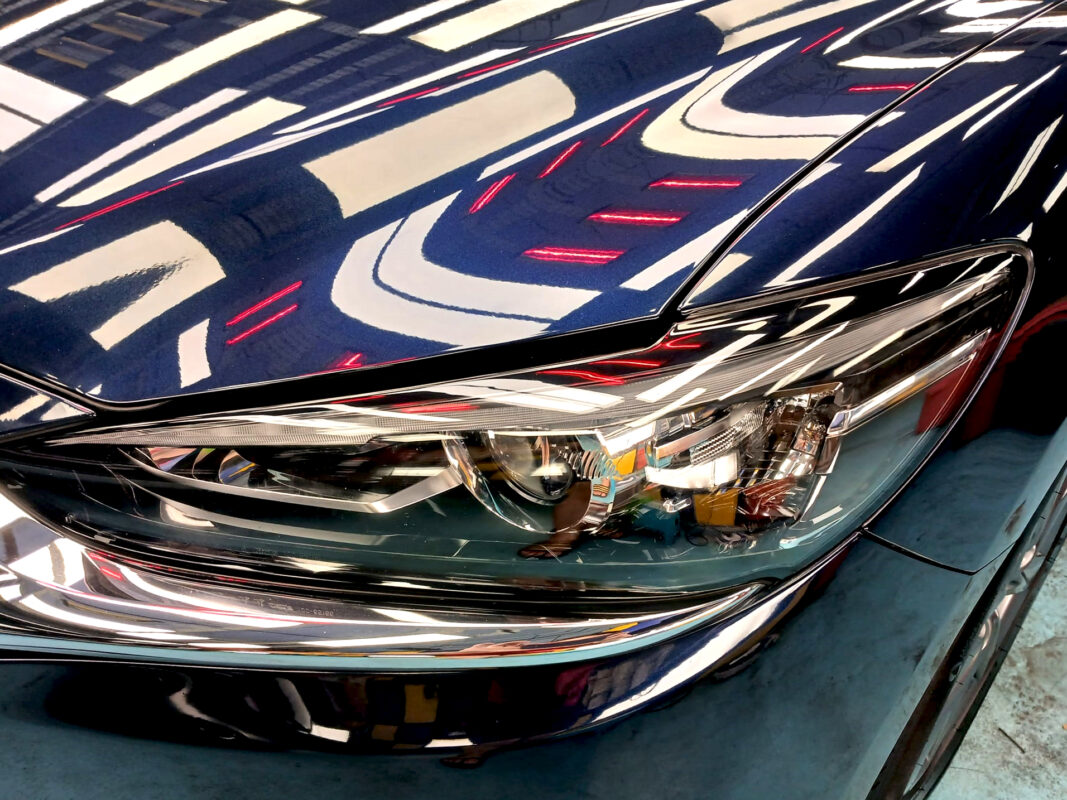 The Mazda 6's coated paintwork showing clean reflections.