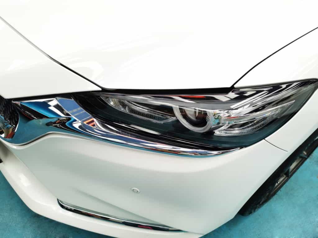 The Mazda 6's coated paintwork showing clean reflections.