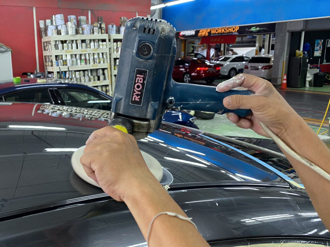 Machine-polishing the Mazda 6 panels to bring up the gloss.