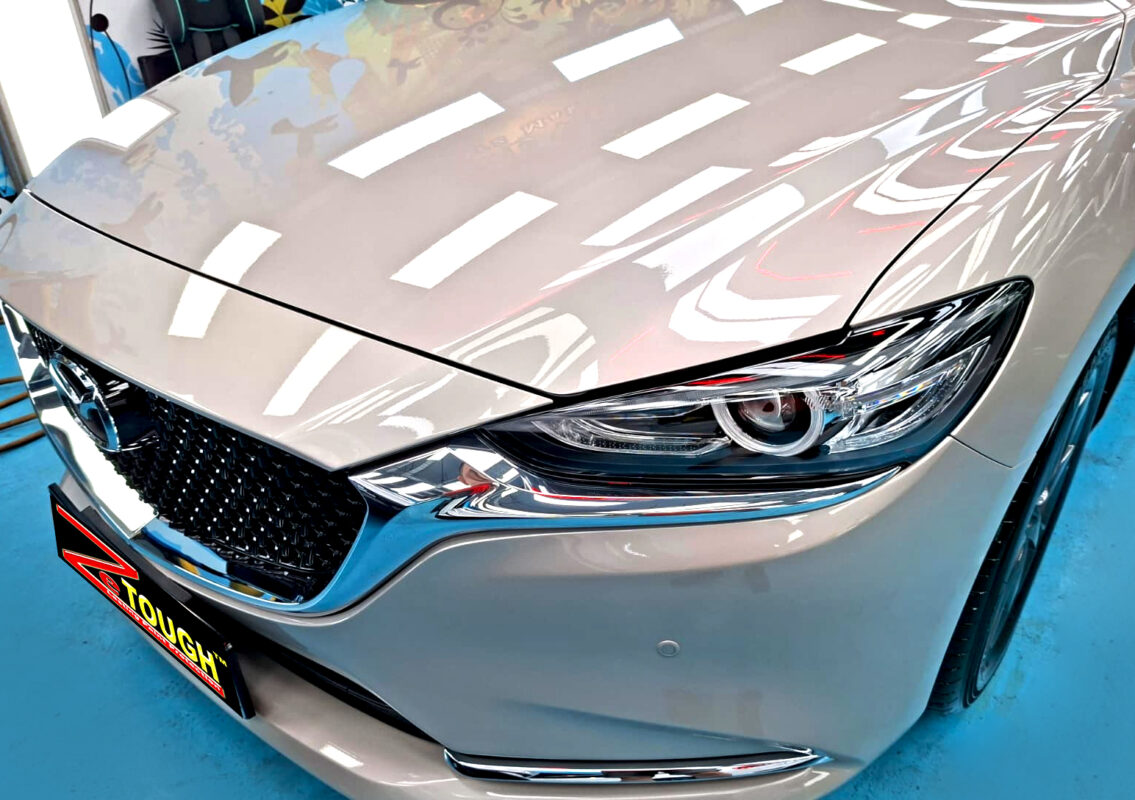 The Mazda 6's coated paintwork under workshop lighting.