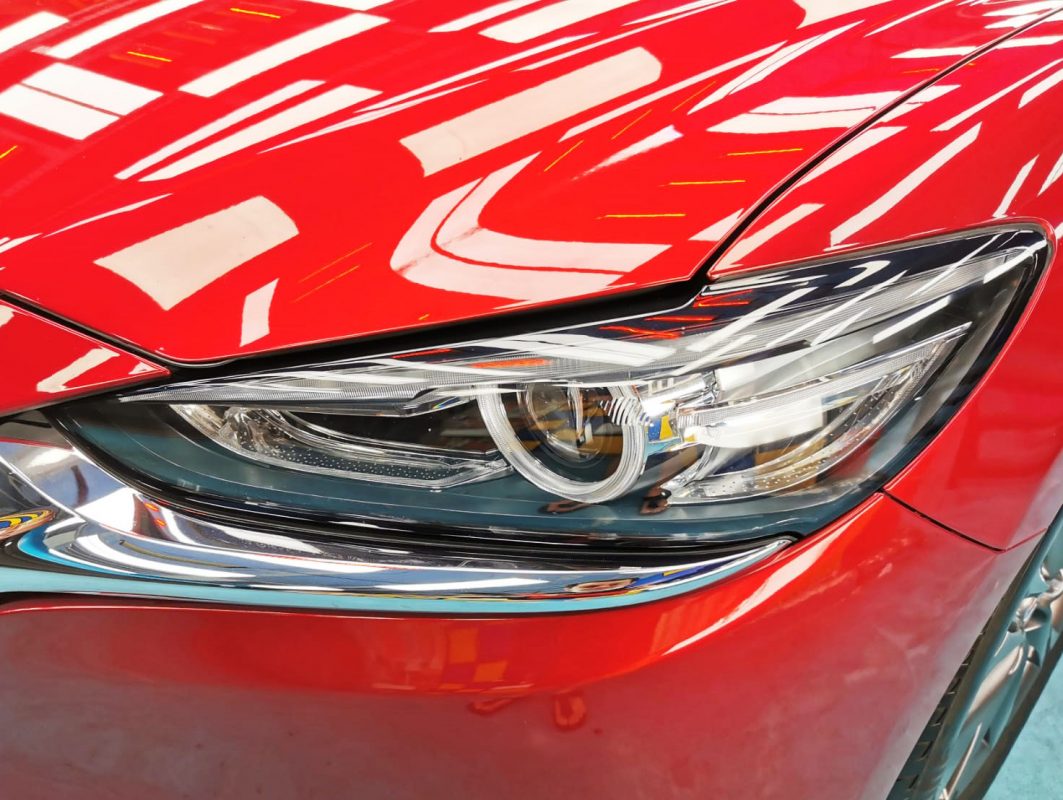 The Mazda 6's coated paintwork showing clean reflections.