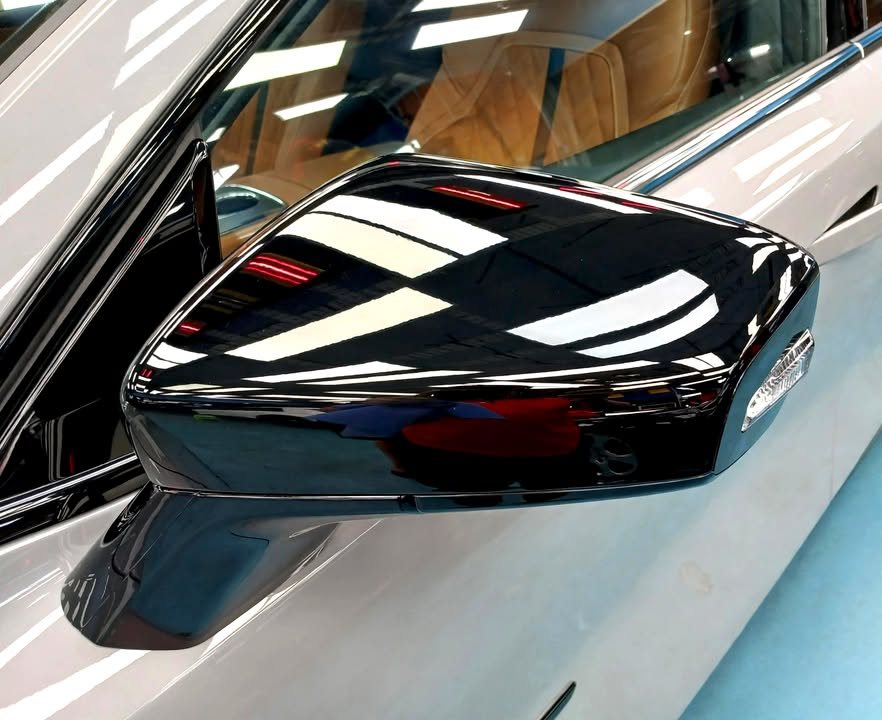 Close-up of the gloss black door mirror on the Mazda 6e.