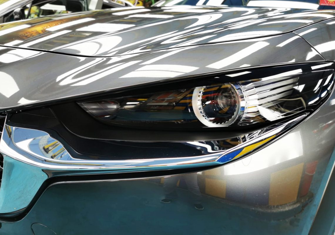 The CX-30's coated paintwork showing clean reflections.