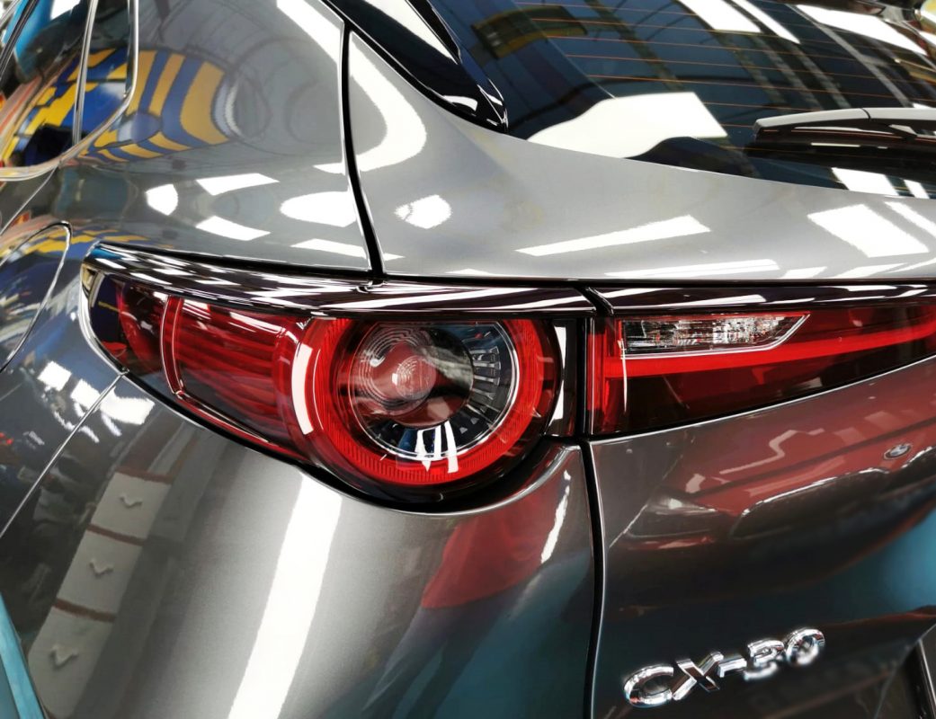 The coated bonnet of the CX-30 under workshop lighting.