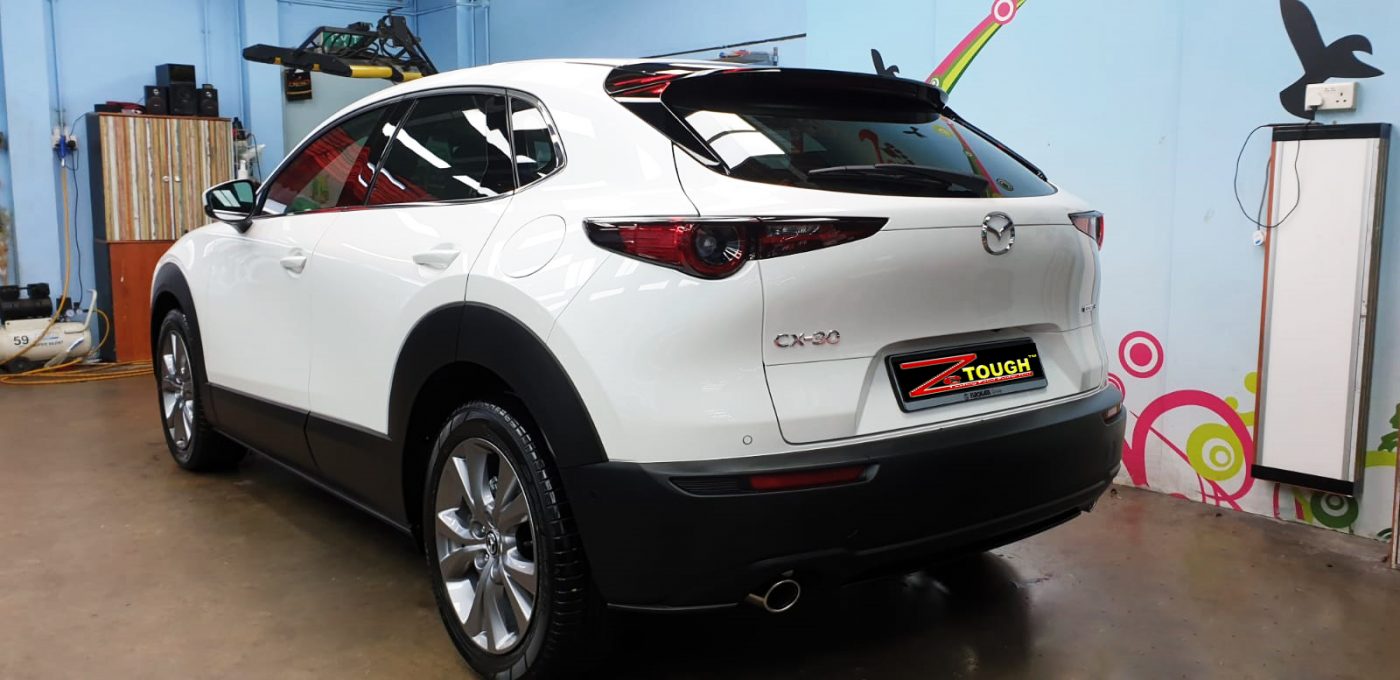 Rear quarter of the CX-30, glossy and protected.