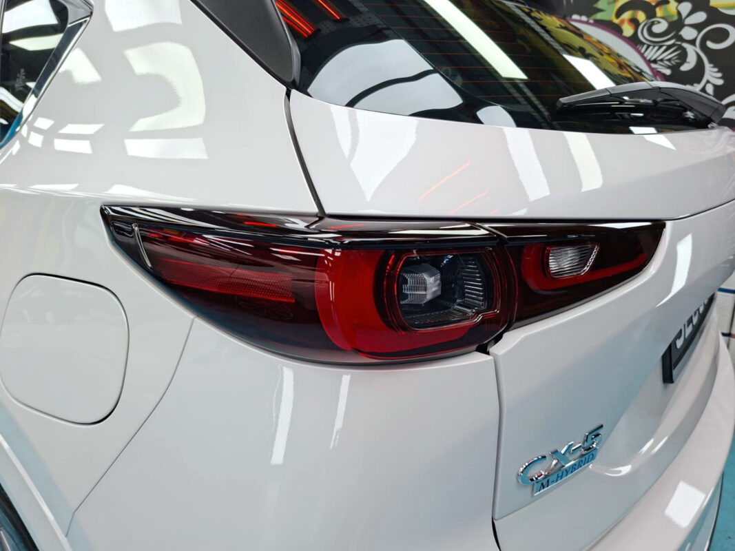 The coated bonnet of the Mazda CX-5 under workshop lighting.