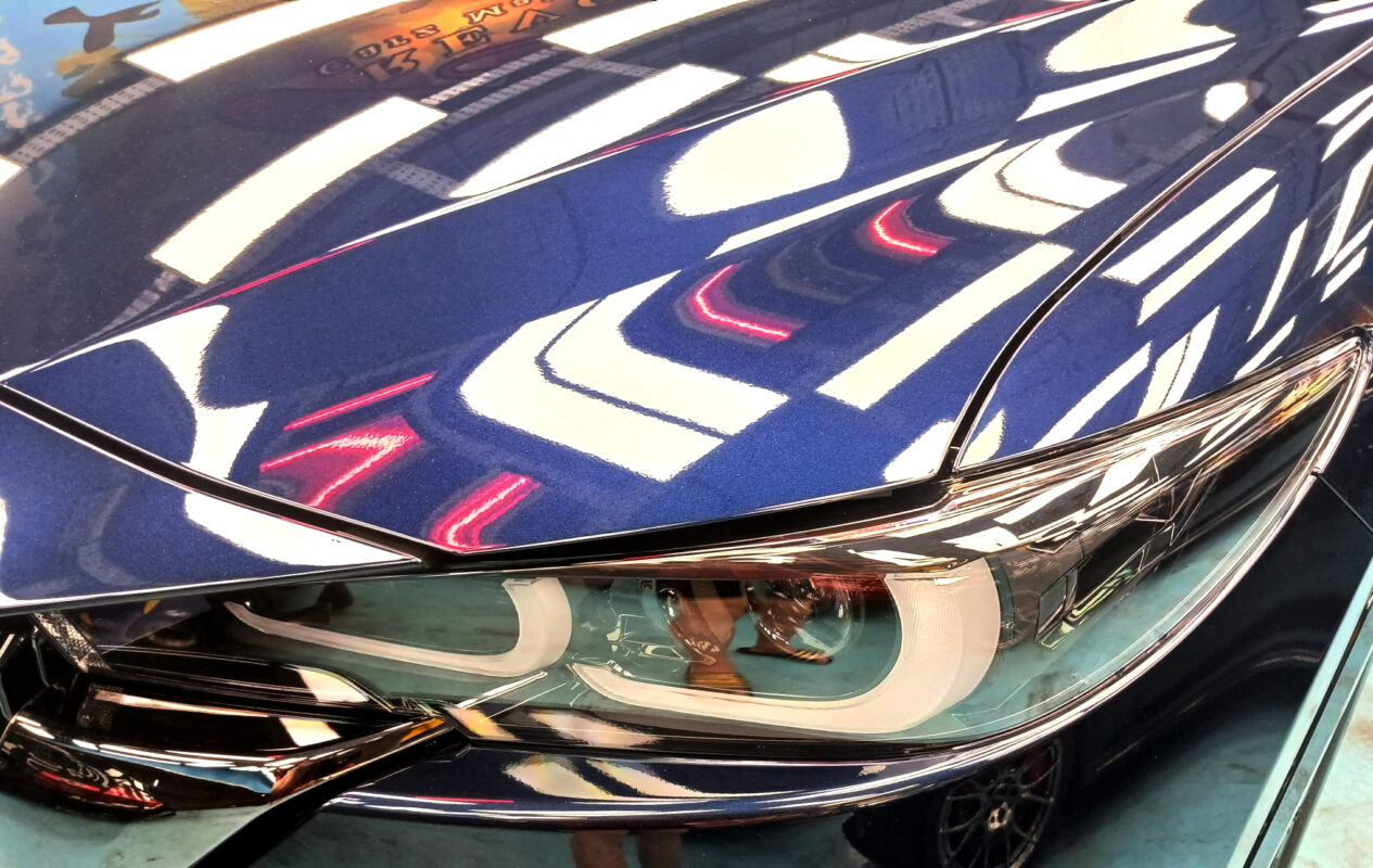 The CX-5's coated paintwork showing clean reflections.