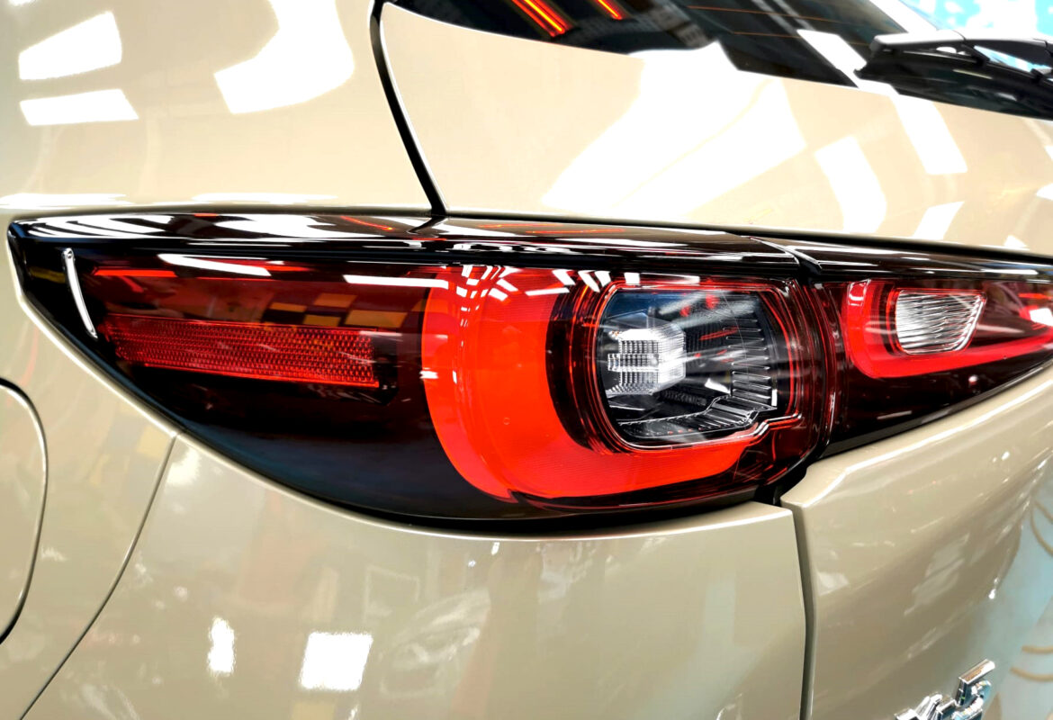 The coated bonnet of the Mazda CX-5 under workshop lighting.