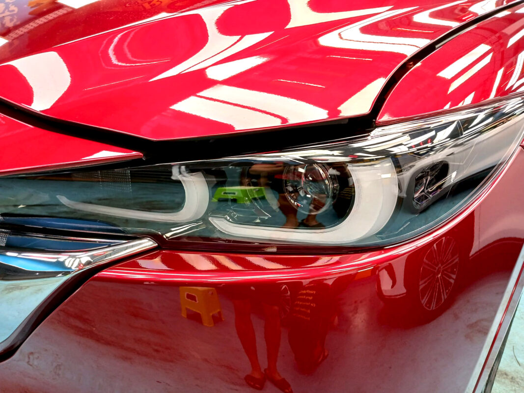 The CX-5's coated paintwork showing clean reflections.