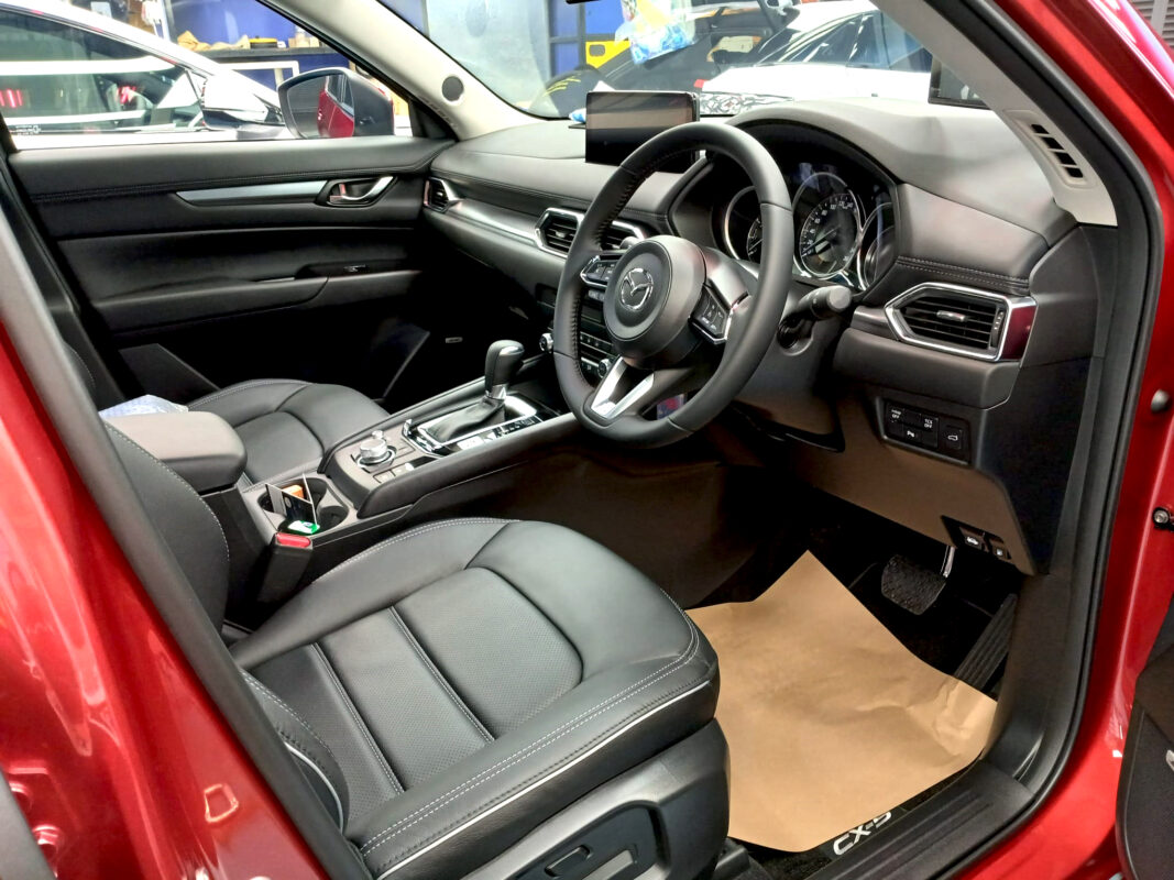 The Mazda CX-5 parked in the workshop, freshly coated.