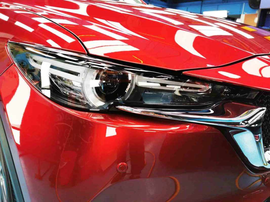 The CX-5's coated paintwork showing clean reflections.