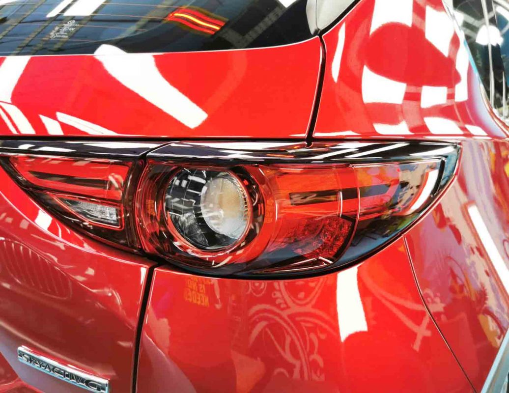 The coated bonnet of the Mazda CX-5 under workshop lighting.