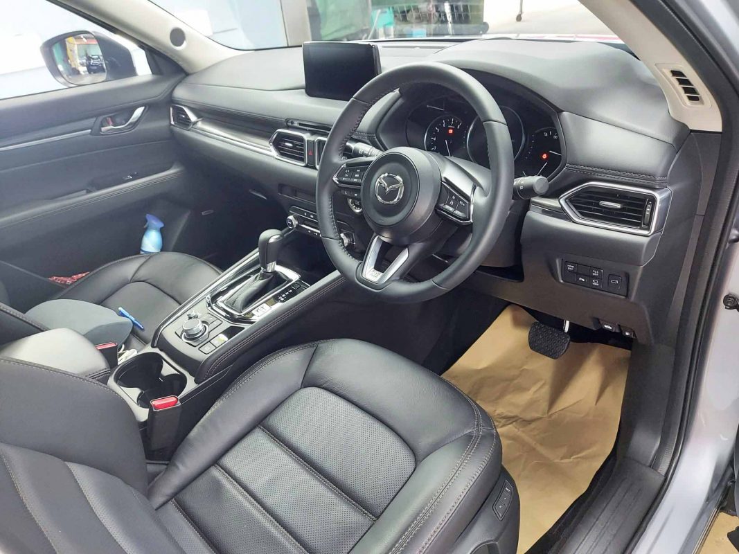 The Mazda CX-5 parked in the workshop, freshly coated.