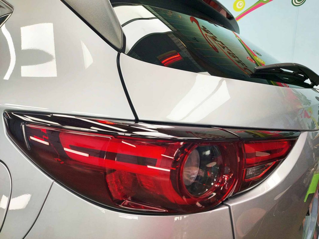 The coated bonnet of the Mazda CX-5 under workshop lighting.
