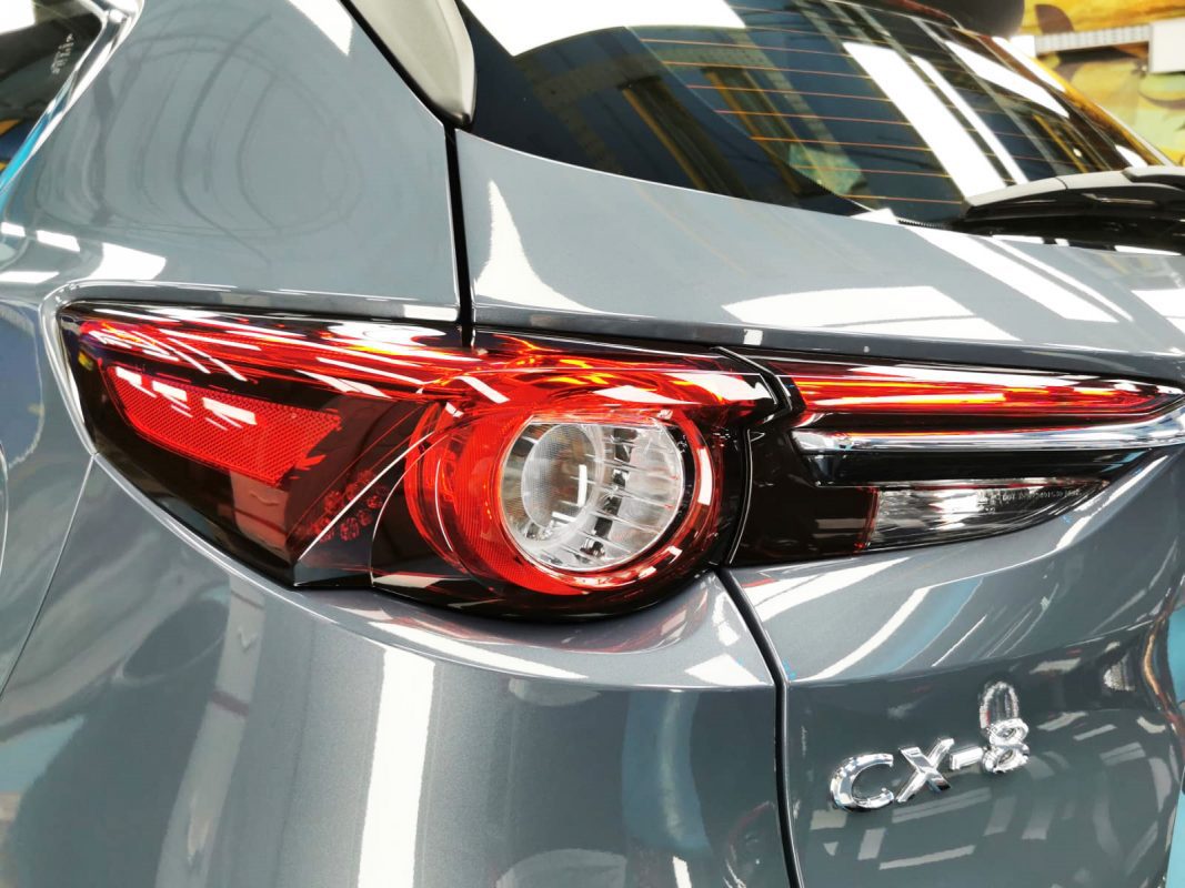 The coated bonnet of the Mazda CX-8 under workshop lighting.